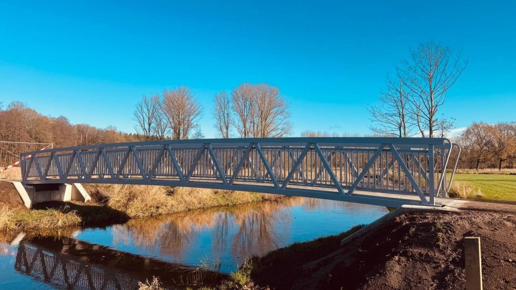 Aluminium truss cycle and pedestrian bridge against the sky