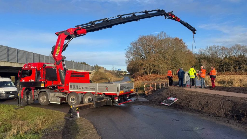 Crane truck and site crew during the installation of an aluminium footbridge