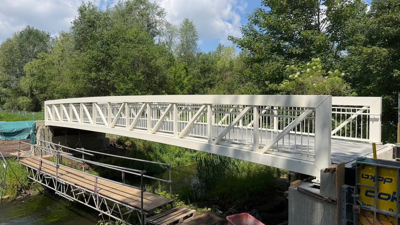 White aluminium truss footbridge over the river Parthe in Leipzig